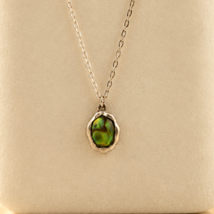 Organic sterling silver pendant with an iridescent peacock-feather mother of pearl oval cabochon, handmade by Rooz Jewellery