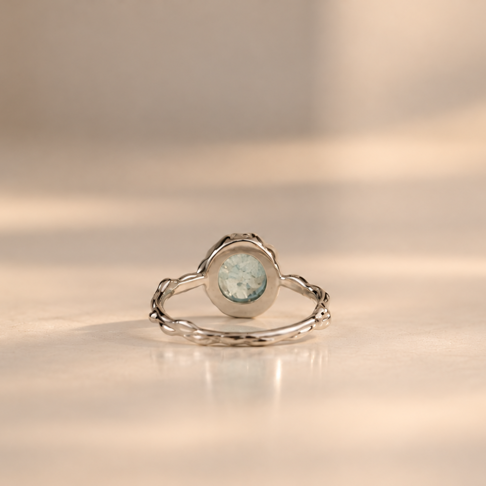 Organic sterling silver ring with a pale blue oval aquamarine cabochon, handmade by Rooz Jewellery in Toronto