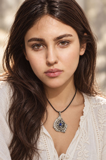 Handmade Persian and ancient Iranian inspired sterling silver medallion pendant with a round natural lapis lazuli cabochon, twisted-rope border and open floral petals, from Rooz Jewellery Shards Collection, on a black genuine leather cord