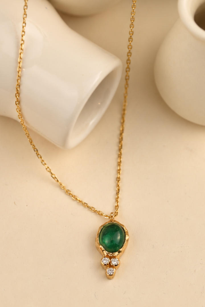 Organic solid 10k gold pendant with a green emerald cabochon and three small lab-grown diamonds, Rooz Jewellery Toronto