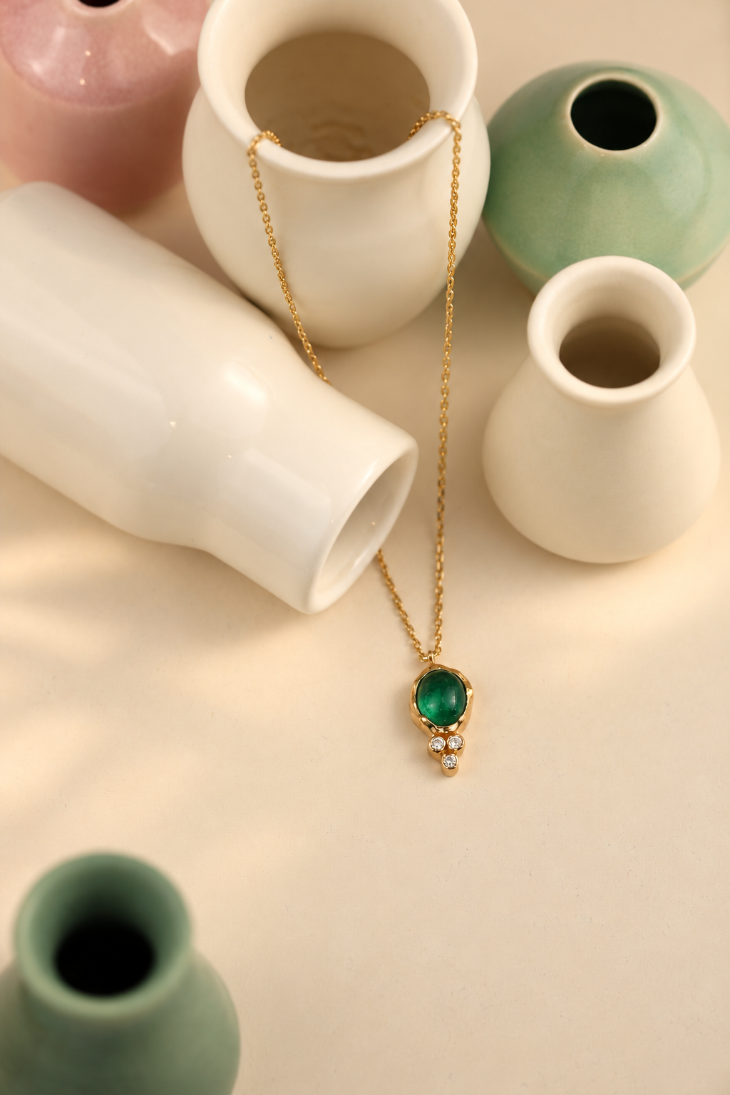 Organic solid 10k gold pendant with a green emerald cabochon and three small lab-grown diamonds, Rooz Jewellery Toronto