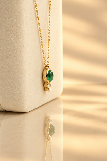 Organic solid 10k gold pendant with a green emerald cabochon and three small lab-grown diamonds, Rooz Jewellery Toronto