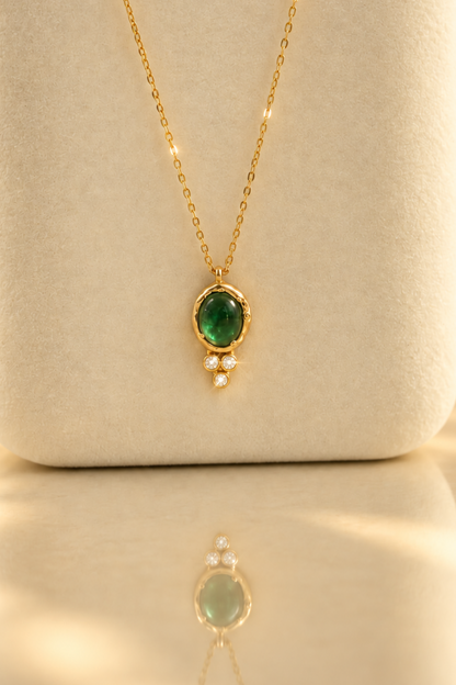 Organic solid 10k gold pendant with a green emerald cabochon and three small lab-grown diamonds, Rooz Jewellery Toronto