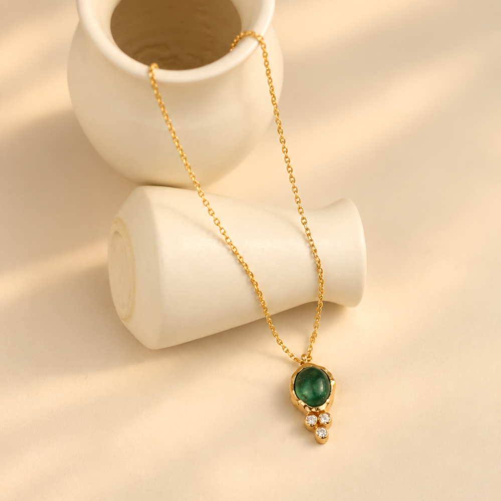Organic solid 10k gold pendant with a green emerald cabochon and three small lab-grown diamonds, Rooz Jewellery Toronto
