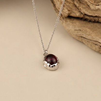Handmade organic sterling silver pendant with a wine-red oval garnet cabochon, Rooz Jewellery Toronto