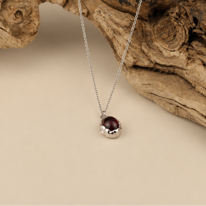 Handmade organic sterling silver pendant with a wine-red oval garnet cabochon, Rooz Jewellery Toronto