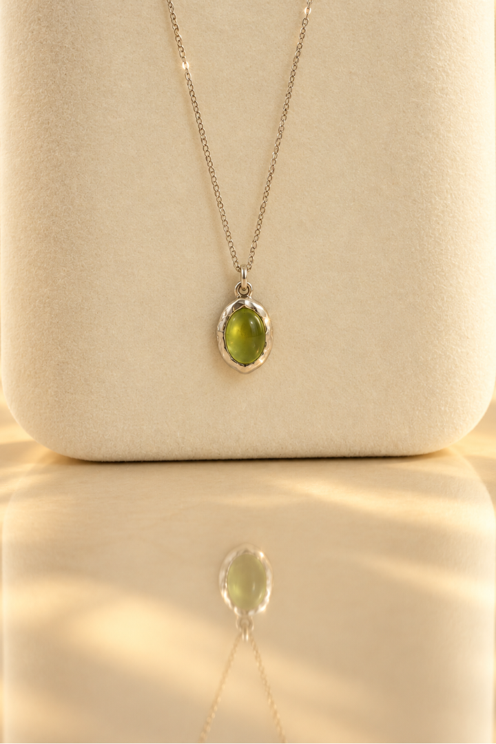 Organic sterling silver pendant with a vivid green oval peridot cabochon, handmade by Rooz Jewellery in Toronto
