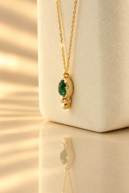 Organic solid 10k gold pendant with a green emerald cabochon and three small lab-grown diamonds, Rooz Jewellery Toronto