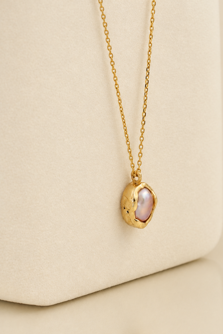 Organic solid 10k gold pendant with an irregular natural freshwater pearl on a gold chain, handmade by Rooz Jewellery