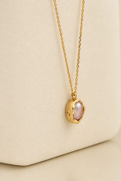 Organic solid 10k gold pendant with an irregular natural freshwater pearl on a gold chain, handmade by Rooz Jewellery