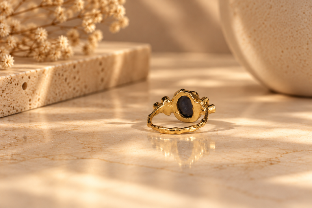 Organic 10k yellow gold ring with a blue sapphire and six small lab-grown diamonds, handmade by Rooz Jewellery