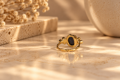 Organic 10k yellow gold ring with a blue sapphire and six small lab-grown diamonds, handmade by Rooz Jewellery