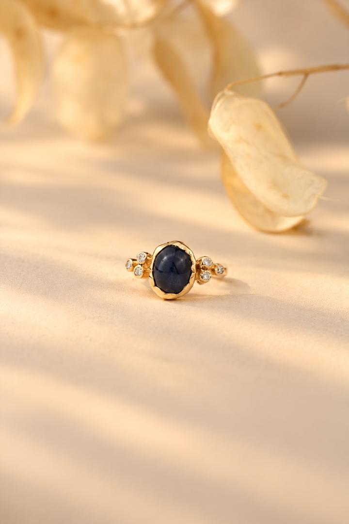 Organic 10k yellow gold ring with a blue sapphire and six small lab-grown diamonds, handmade by Rooz Jewellery