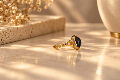 Organic 10k yellow gold ring with a blue sapphire and six small lab-grown diamonds, handmade by Rooz Jewellery