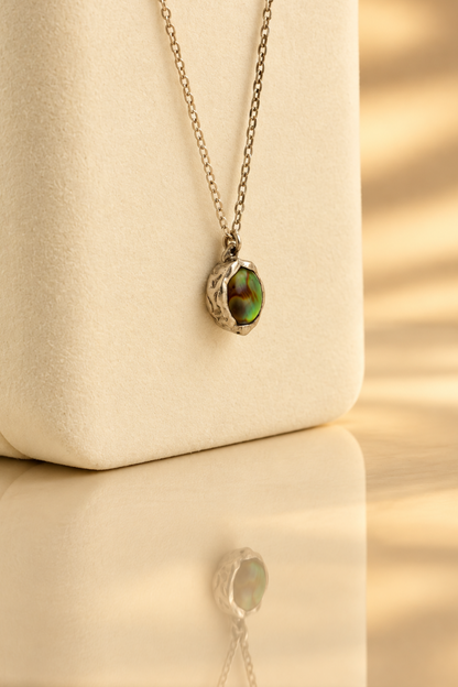 Organic sterling silver pendant with an iridescent peacock-feather mother of pearl oval cabochon, handmade by Rooz Jewellery