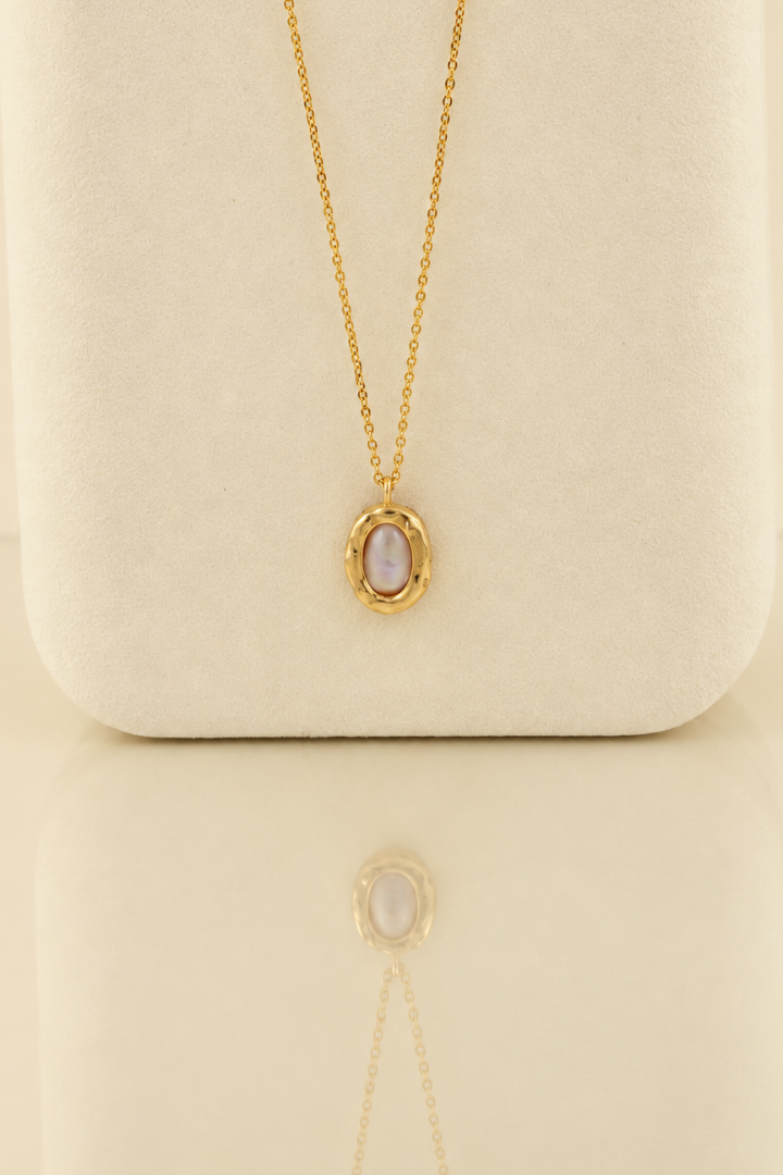 Organic solid 10k gold pendant with an irregular natural freshwater pearl on a gold chain, handmade by Rooz Jewellery