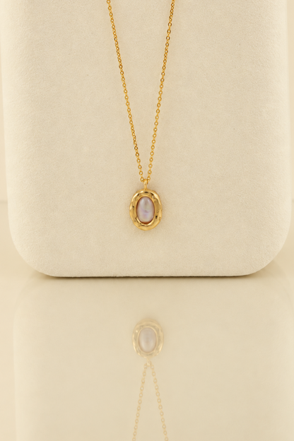 Organic solid 10k gold pendant with an irregular natural freshwater pearl on a gold chain, handmade by Rooz Jewellery