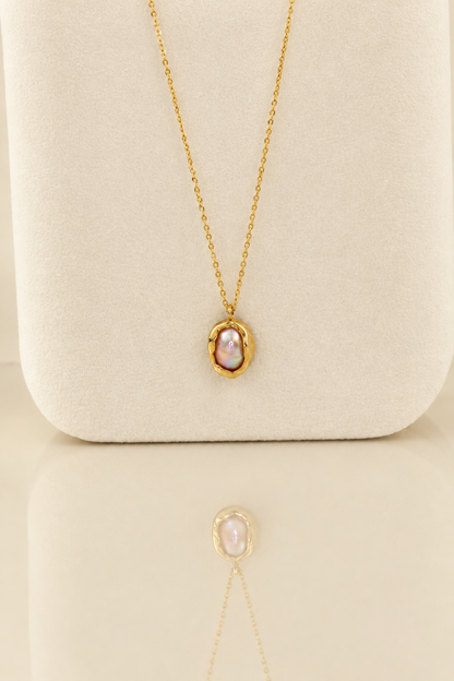 Organic solid 10k gold pendant with an irregular natural freshwater pearl on a gold chain, handmade by Rooz Jewellery