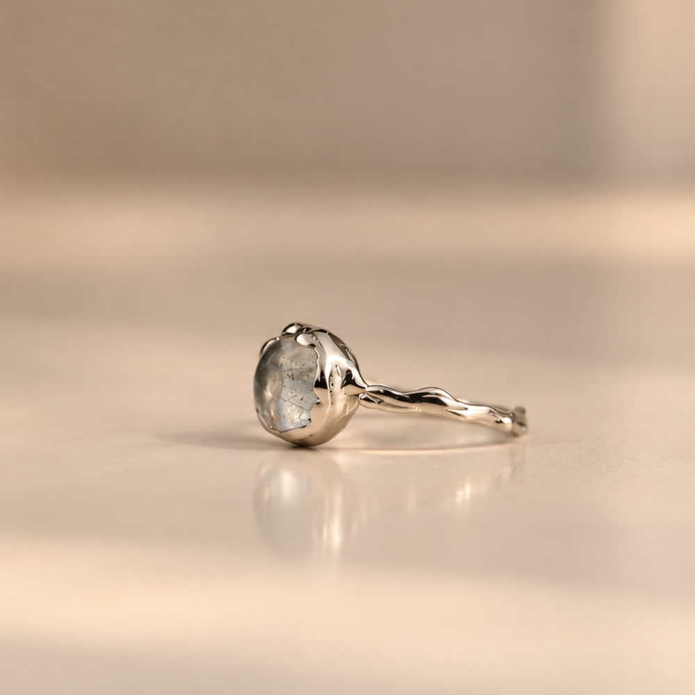 Organic sterling silver ring with a pale blue oval aquamarine cabochon, handmade by Rooz Jewellery in Toronto