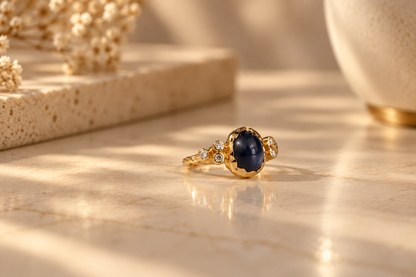 Organic 10k yellow gold ring with a blue sapphire and six small lab-grown diamonds, handmade by Rooz Jewellery