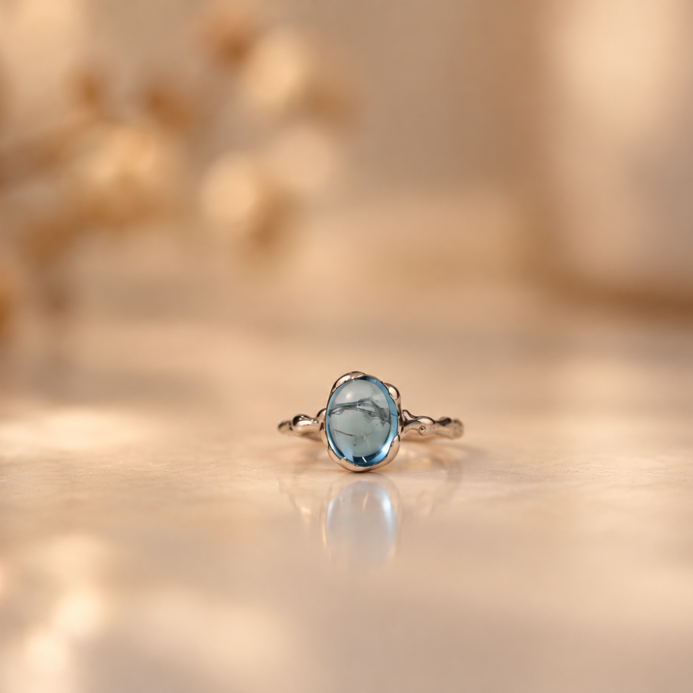 Handmade organic sterling silver ring with a light blue topaz oval cabochon, Rooz Jewellery Toronto