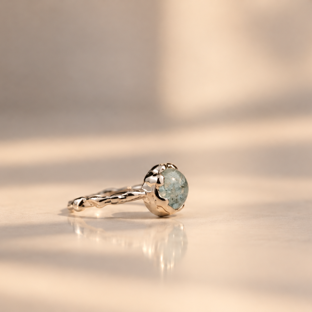 Organic sterling silver ring with a pale blue oval aquamarine cabochon, handmade by Rooz Jewellery in Toronto